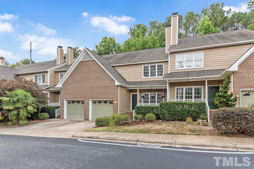 7030 Sandy Forks Road, Unit 103 Raleigh, NC 27615 - Photo 27 of 36 a front view of a house with a yard and potted plants
