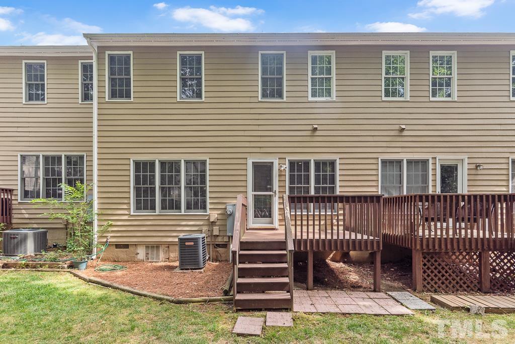 7030 Sandy Forks Road, Unit 103 Raleigh, NC 27615 - Photo 28 of 36 a front view of a house with a garden