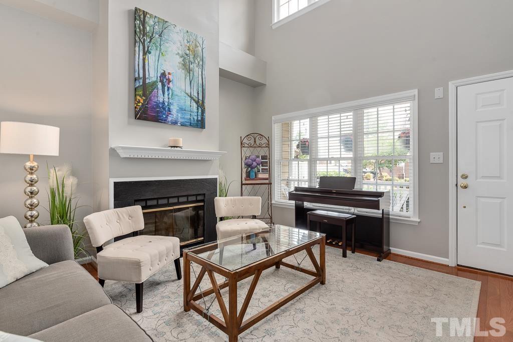 7030 Sandy Forks Road, Unit 103 Raleigh, NC 27615 - Photo 3 of 36 a living room with furniture a fireplace and a window