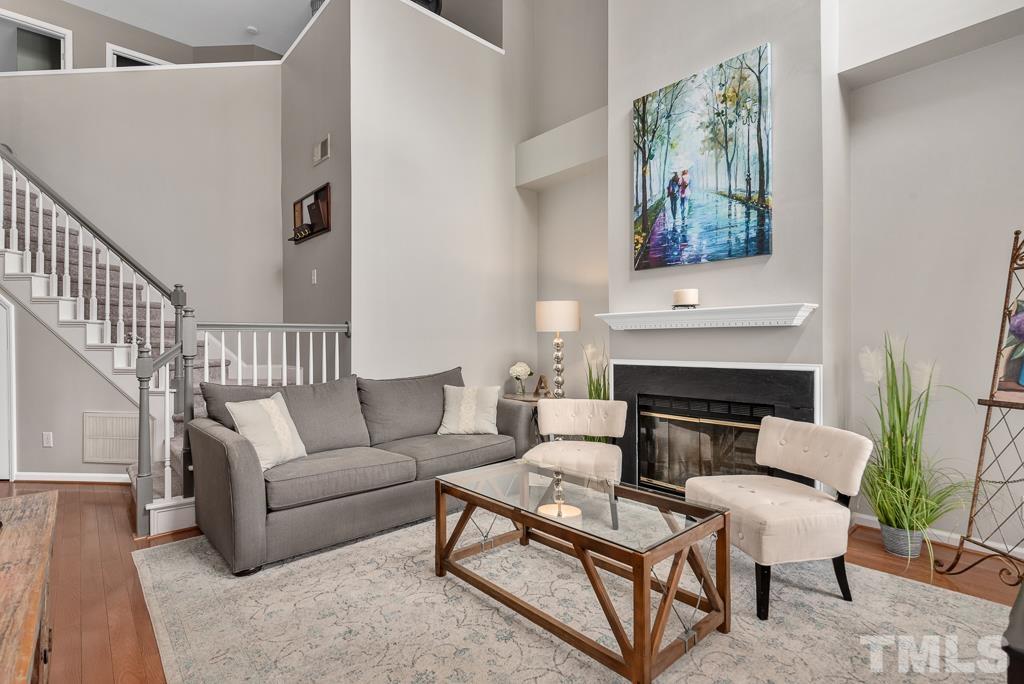 7030 Sandy Forks Road, Unit 103 Raleigh, NC 27615 - Photo 5 of 36 a living room with furniture and a fireplace