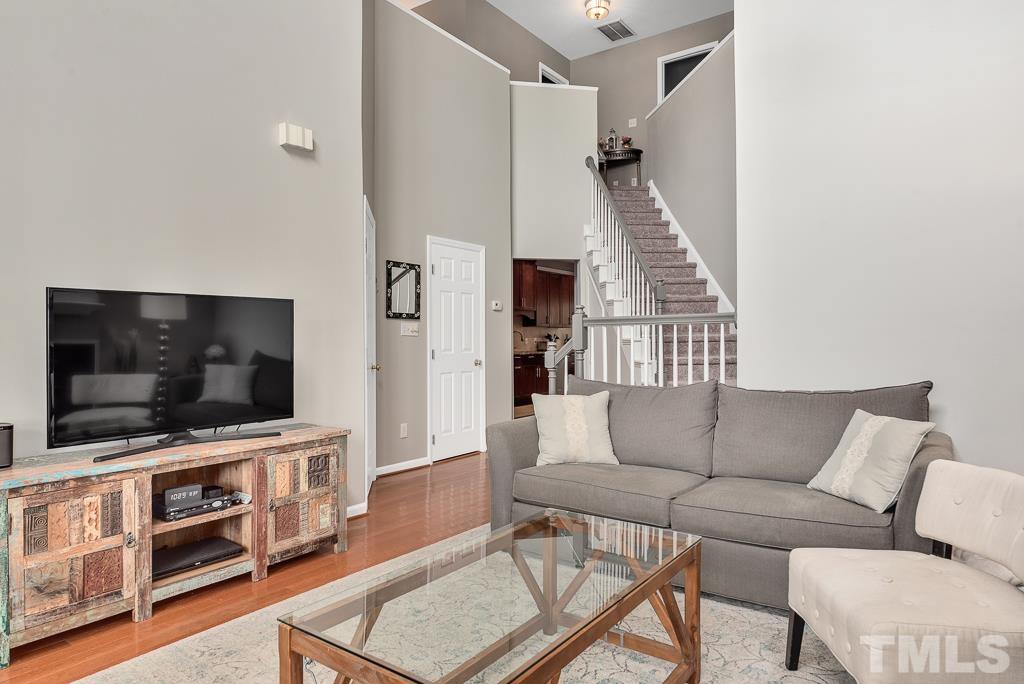7030 Sandy Forks Road, Unit 103 Raleigh, NC 27615 - Photo 6 of 36 a living room with furniture and a flat screen tv