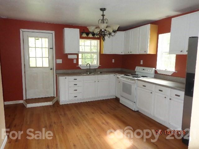 40 Royal Fern Road Sylva, NC 28779 - Photo 8 of 9 a kitchen with granite countertop a sink cabinets and wooden floor