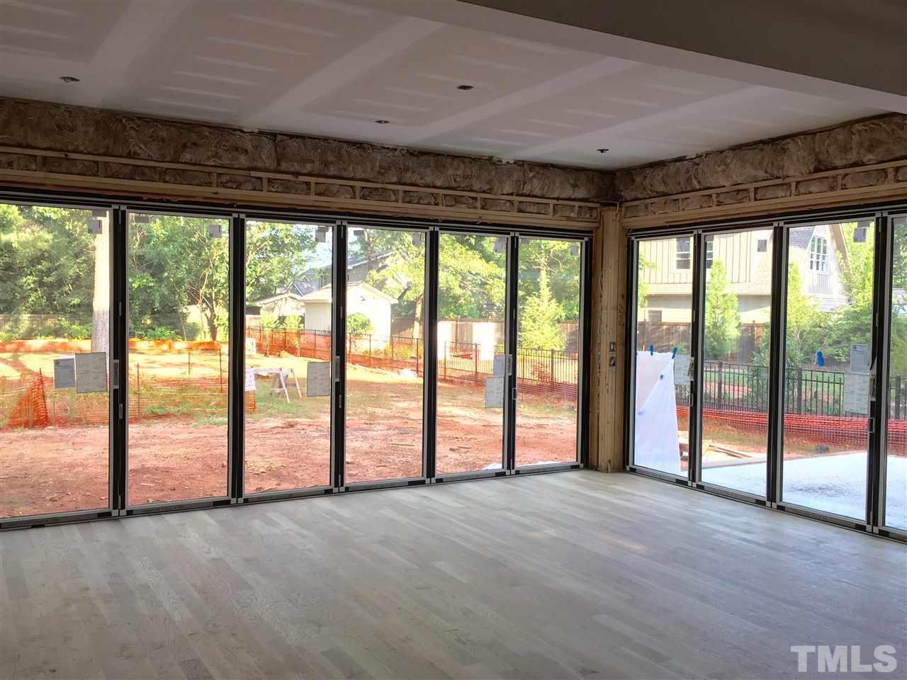 1416 Ridge Road Raleigh, NC 27607 - Photo 4 of 11 a view of an empty room with large windows