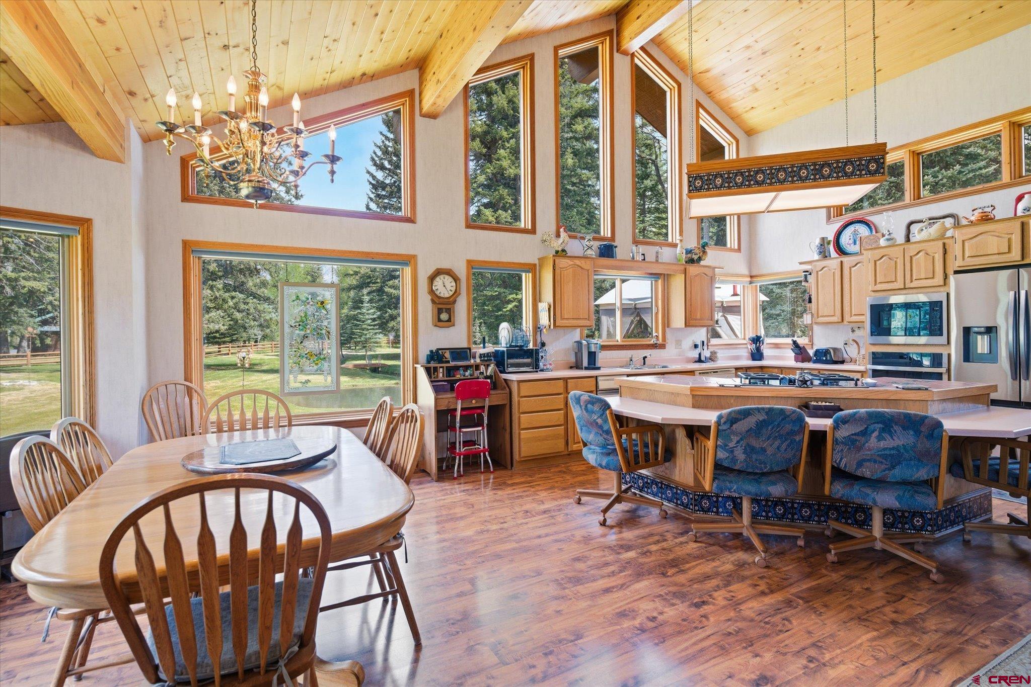 197 Hummingbird Way Bayfield, CO 81122 - Photo 12 of 44 a view of a dining room with furniture a chandelier and wooden floor