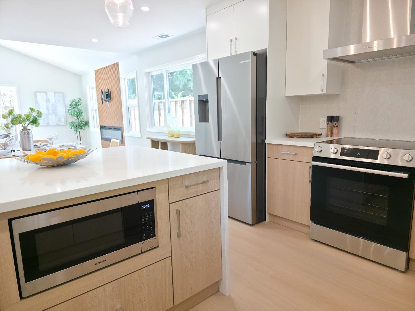 6746 Bollinger Road San Jose, CA 95129 - Photo 7 of 30 a kitchen with stainless steel appliances a stove a microwave and a refrigerator