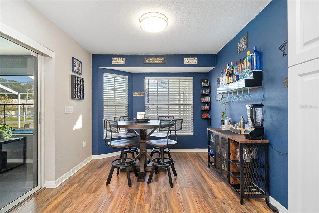 10464 Henderson Street Spring Hill, FL 34608 - Photo 19 of 62 a view of a dining room with furniture and wooden floor