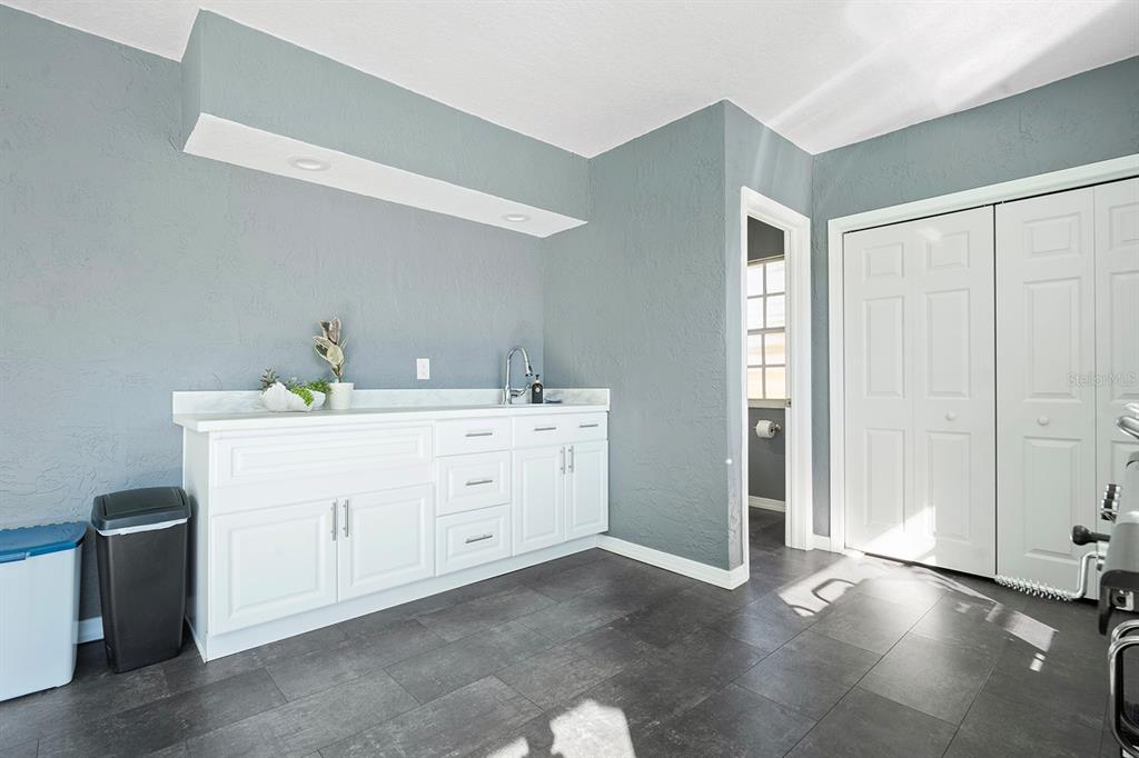10464 Henderson Street Spring Hill, FL 34608 - Photo 22 of 62 a bathroom with a double vanity sink a mirror and a shower