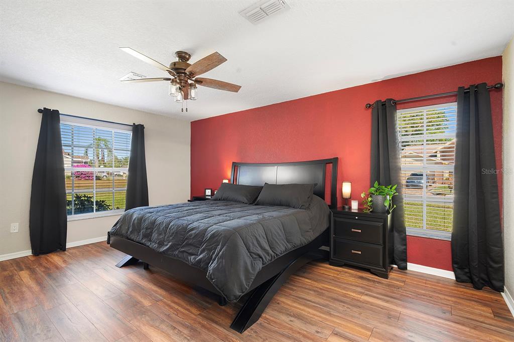 10464 Henderson Street Spring Hill, FL 34608 - Photo 30 of 62 a bedroom with a bed and dresser with mirror