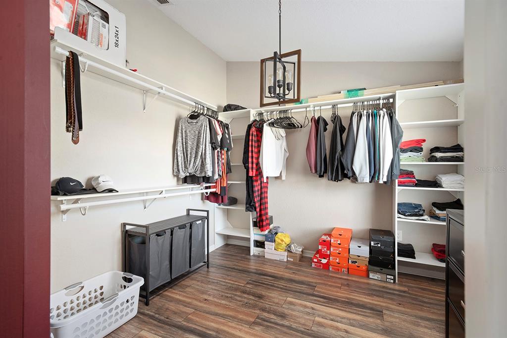 10464 Henderson Street Spring Hill, FL 34608 - Photo 32 of 62 a view of walk in closet with clothes and shoes