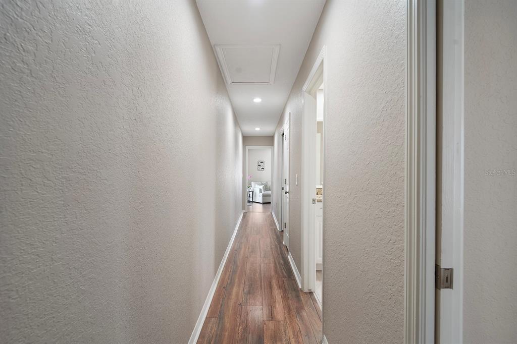 10464 Henderson Street Spring Hill, FL 34608 - Photo 36 of 62 a view of a hallway with wooden floor