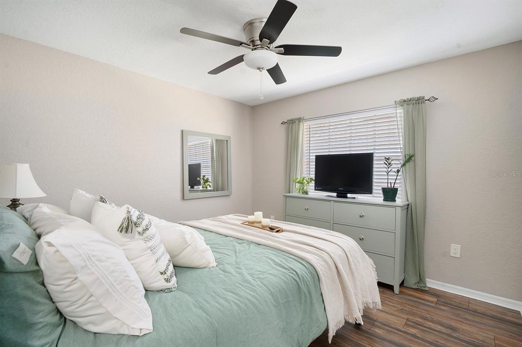 10464 Henderson Street Spring Hill, FL 34608 - Photo 41 of 62 a bedroom with a bed and a flat screen tv