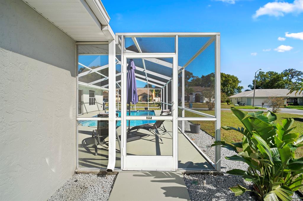 10464 Henderson Street Spring Hill, FL 34608 - Photo 58 of 62 a view of a patio with table and chairs and potted plants