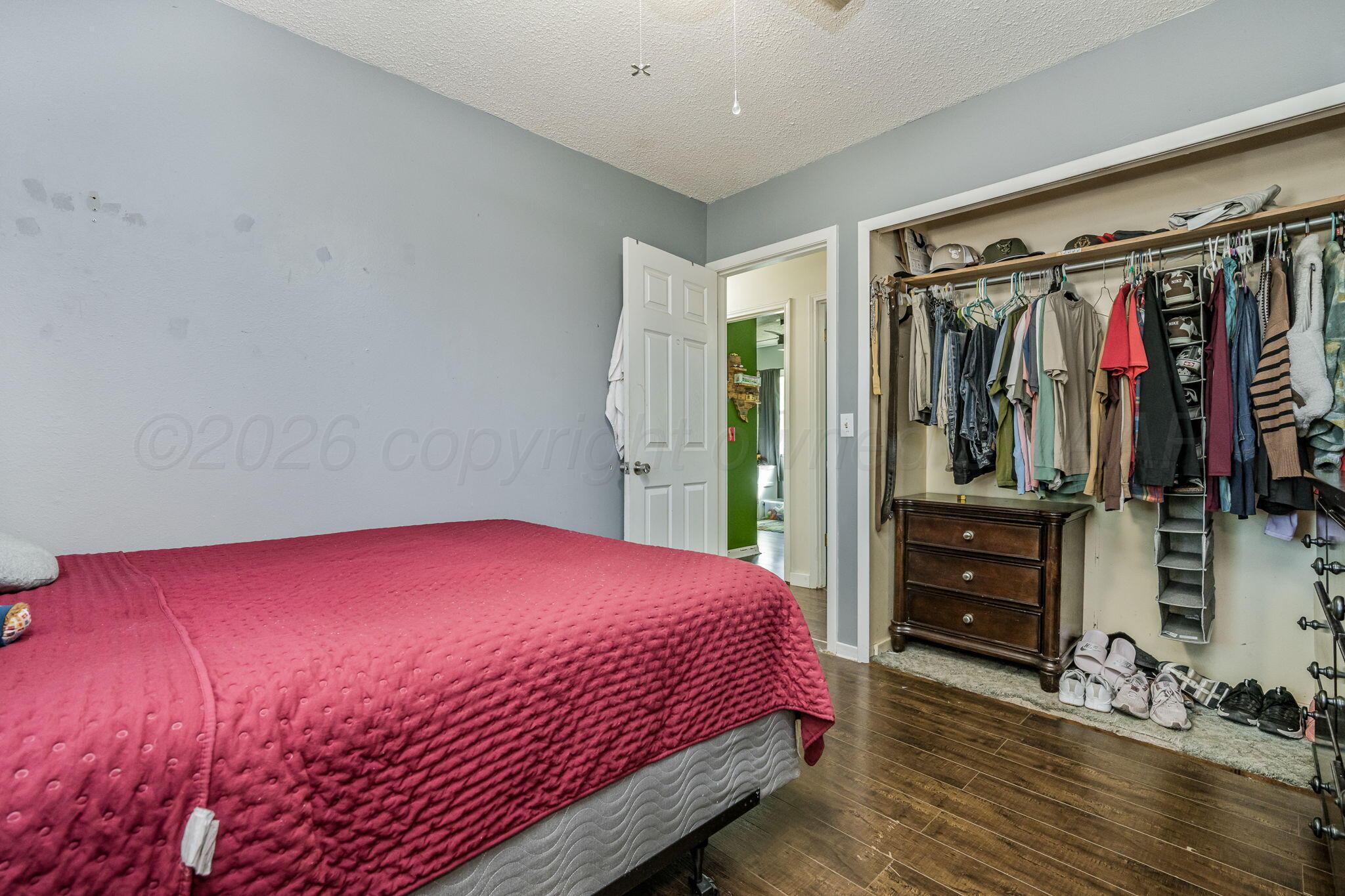 2907 South Manhattan Street Amarillo, TX 79103 - Photo 13 of 16 a bedroom with a bed and a closet