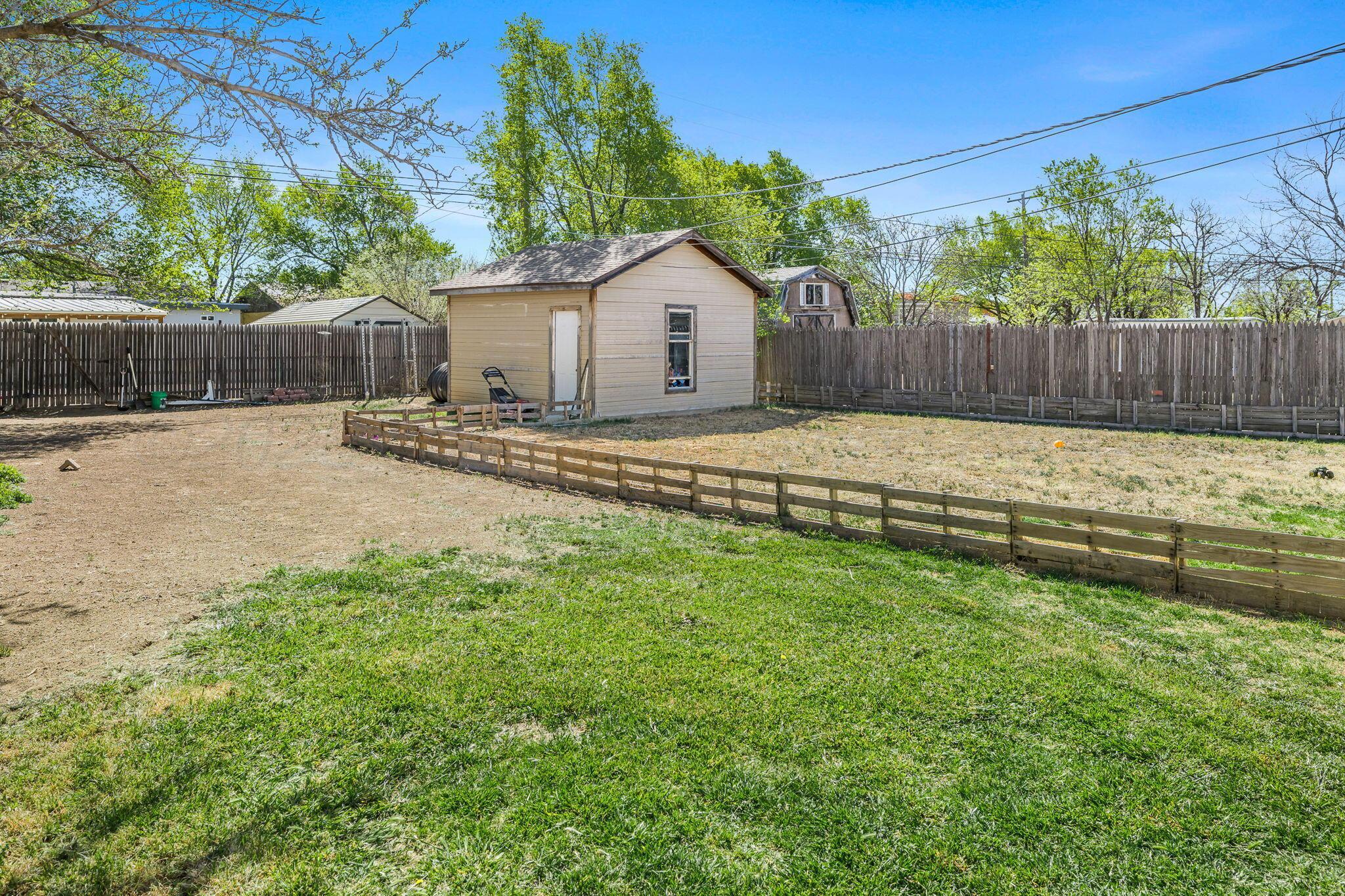 2907 South Manhattan Street Amarillo, TX 79103 - Photo 15 of 16 a view of a backyard with a fence and wooden fence