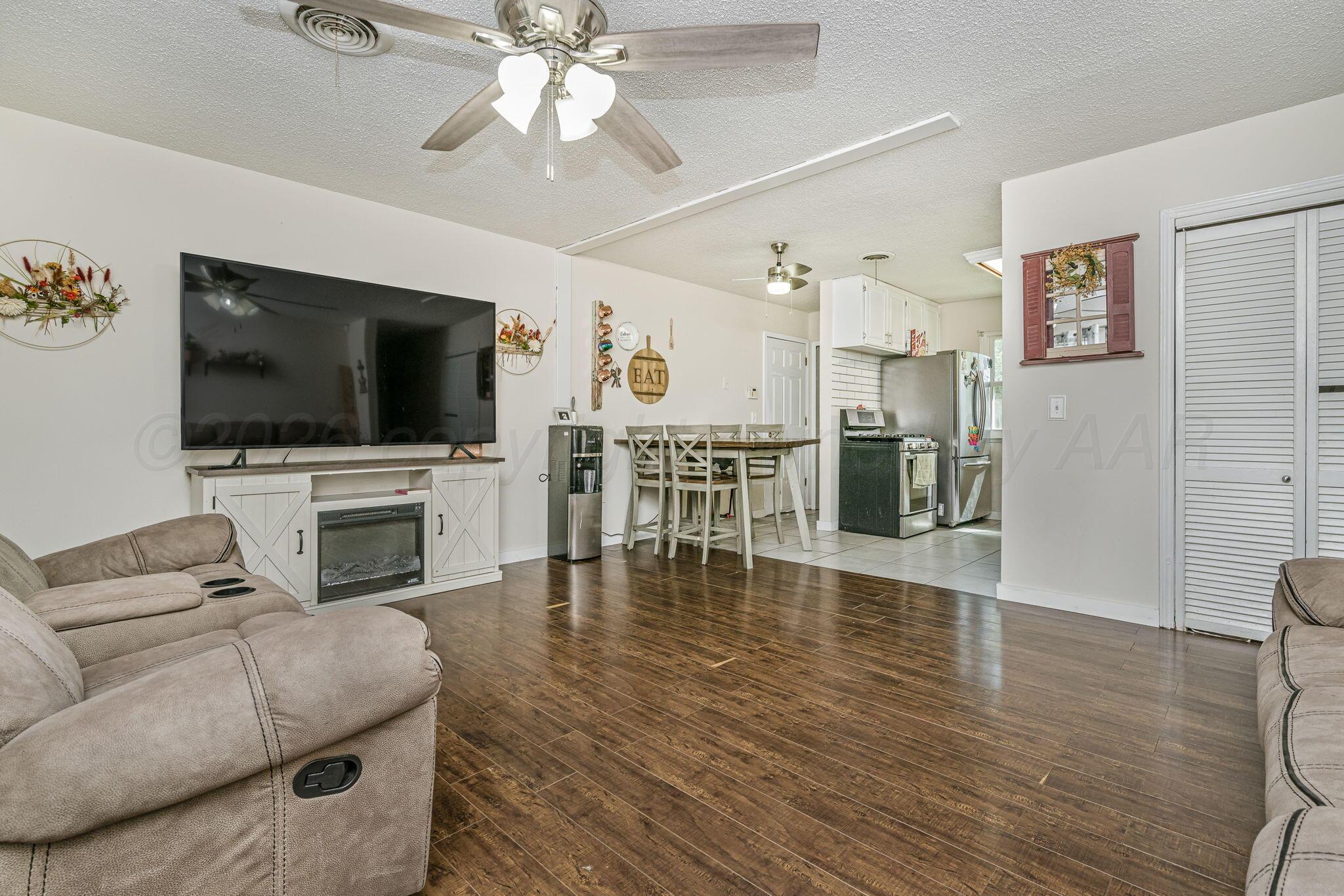 2907 South Manhattan Street Amarillo, TX 79103 - Photo 3 of 16 a living room with furniture and a flat screen tv