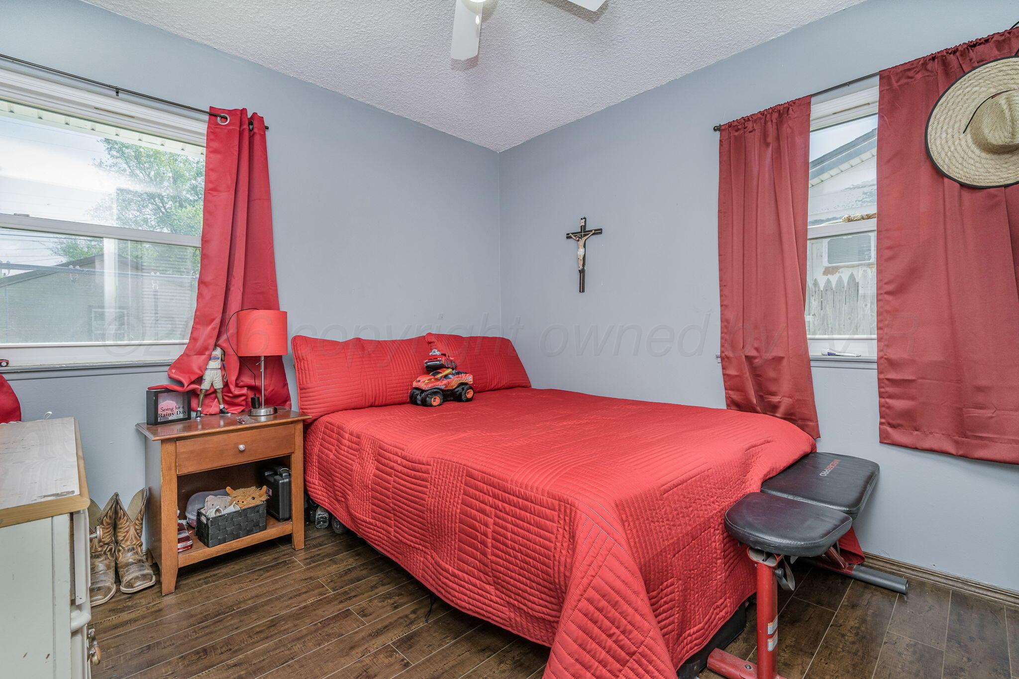 2907 South Manhattan Street Amarillo, TX 79103 - Photo 10 of 16 a bedroom with a bed and a window