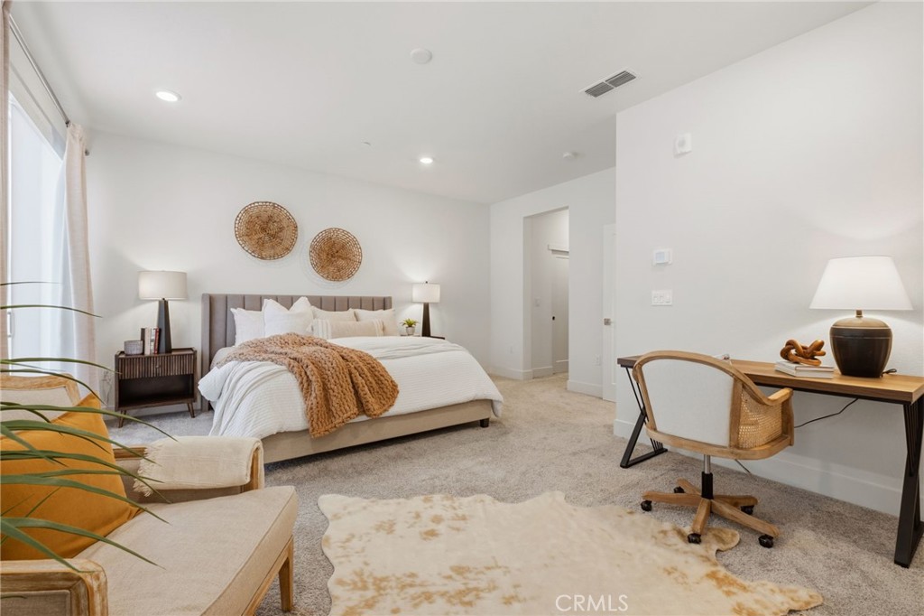 45235 Wisdom Road, Unit 1003 Fremont, CA 94538 - Photo 12 of 32 a bedroom with a bed and chair
