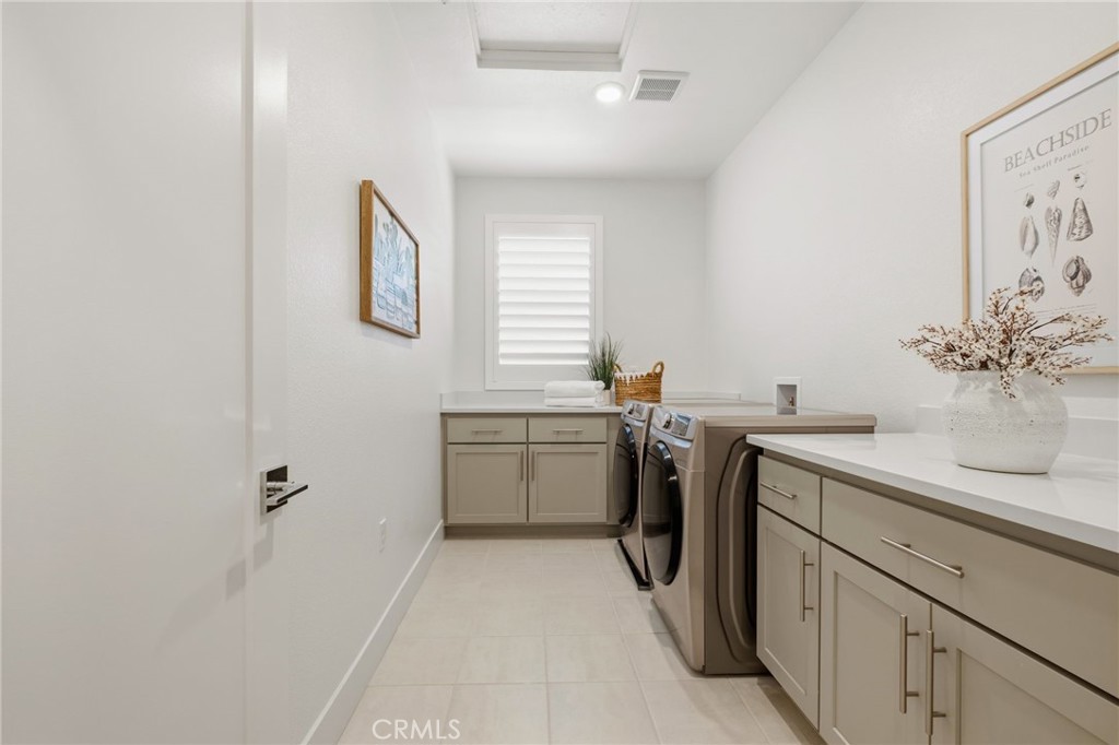 45235 Wisdom Road, Unit 1003 Fremont, CA 94538 - Photo 14 of 32 a utility room with cabinets washer and dryer