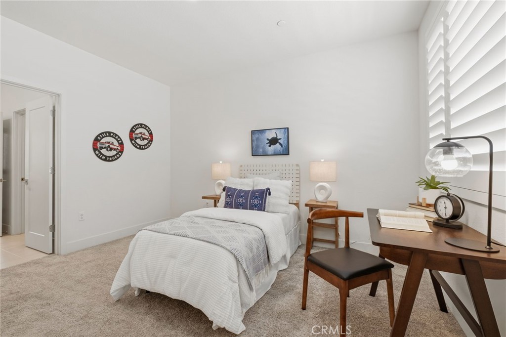 45235 Wisdom Road, Unit 1003 Fremont, CA 94538 - Photo 15 of 32 a bedroom with a bed and a table in it