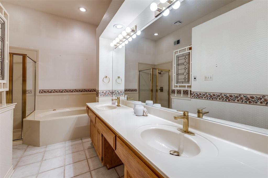 9939 Waterfront Trail Rowlett, TX 75087 - Photo 19 of 25 a bathroom with a granite countertop sink a toilet a bathtub and mirror