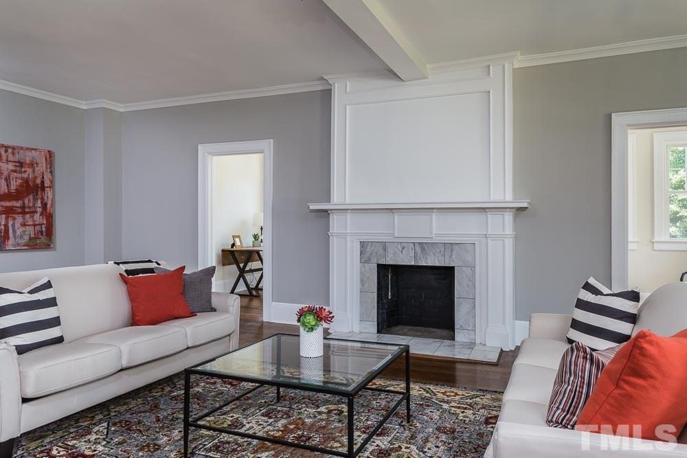 2417 Fairview Road Raleigh, NC 27608 - Photo 4 of 25 a living room with furniture and a fireplace