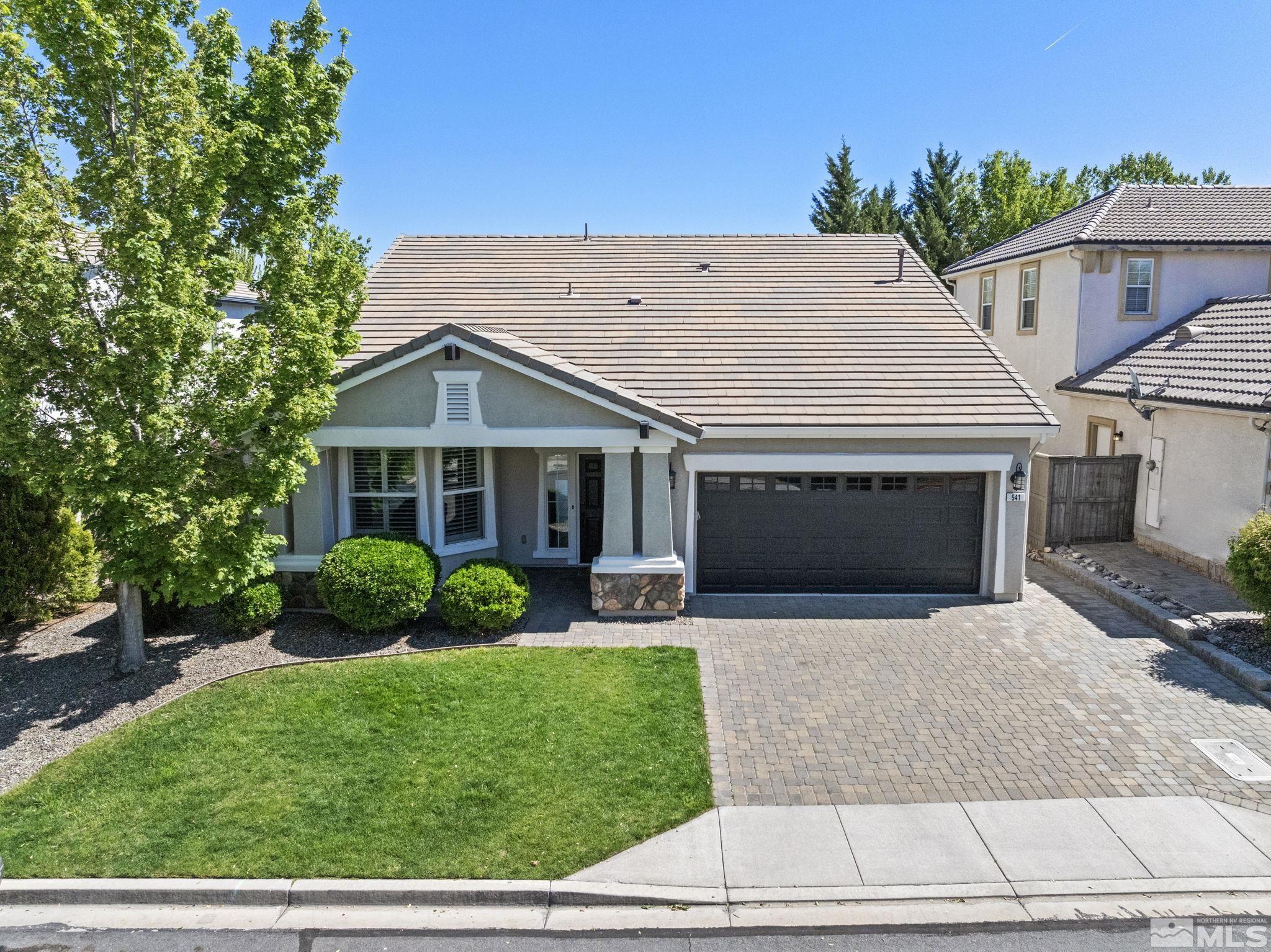 541 Needles Court Reno, NV 89521 - Photo 1 of 35 a front view of a house with a yard and garage