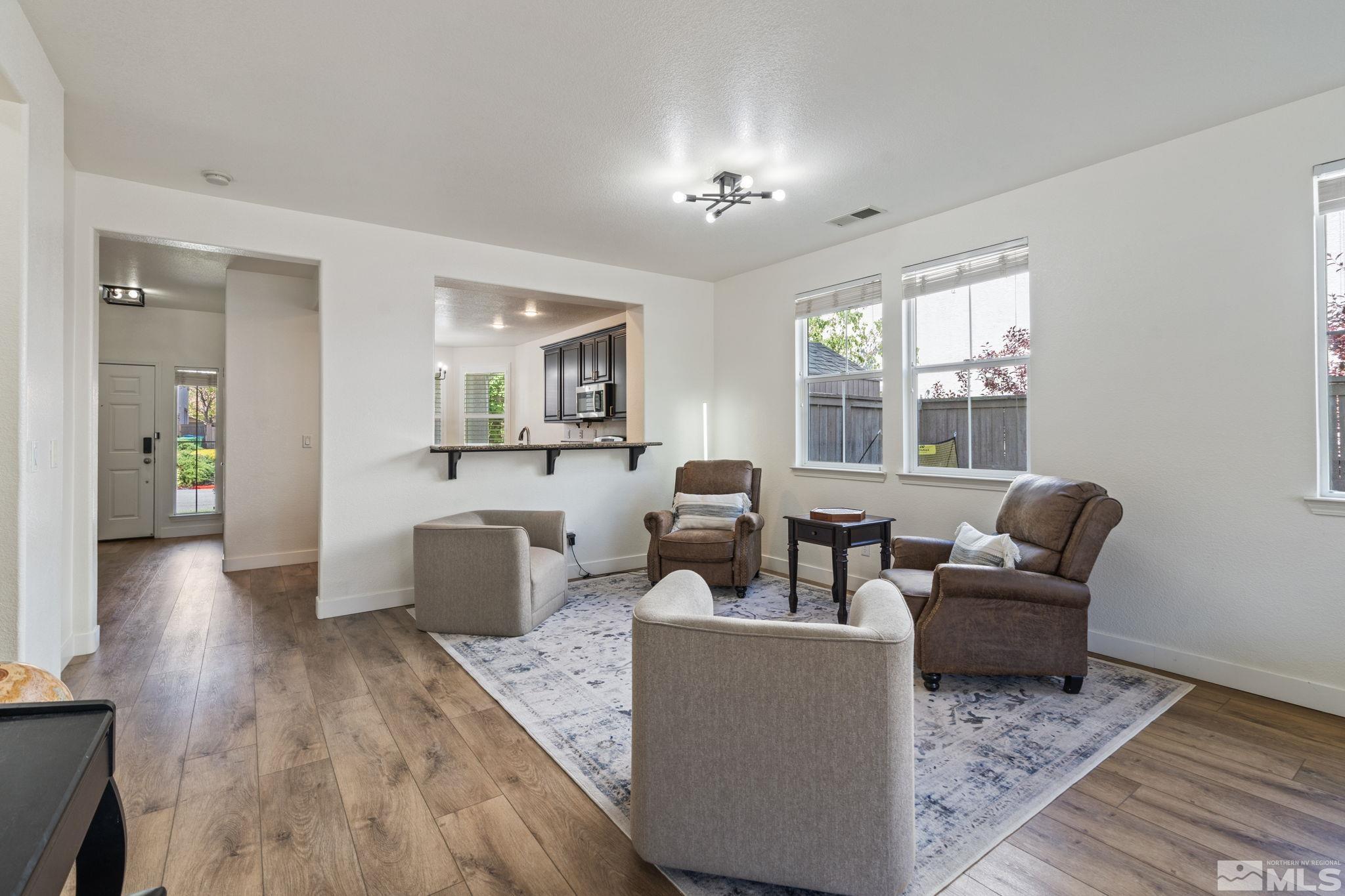 541 Needles Court Reno, NV 89521 - Photo 12 of 35 a living room with furniture and a chandelier