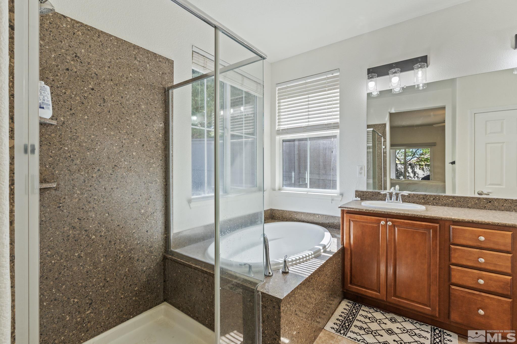 541 Needles Court Reno, NV 89521 - Photo 14 of 35 a bathroom with a tub sink and mirror