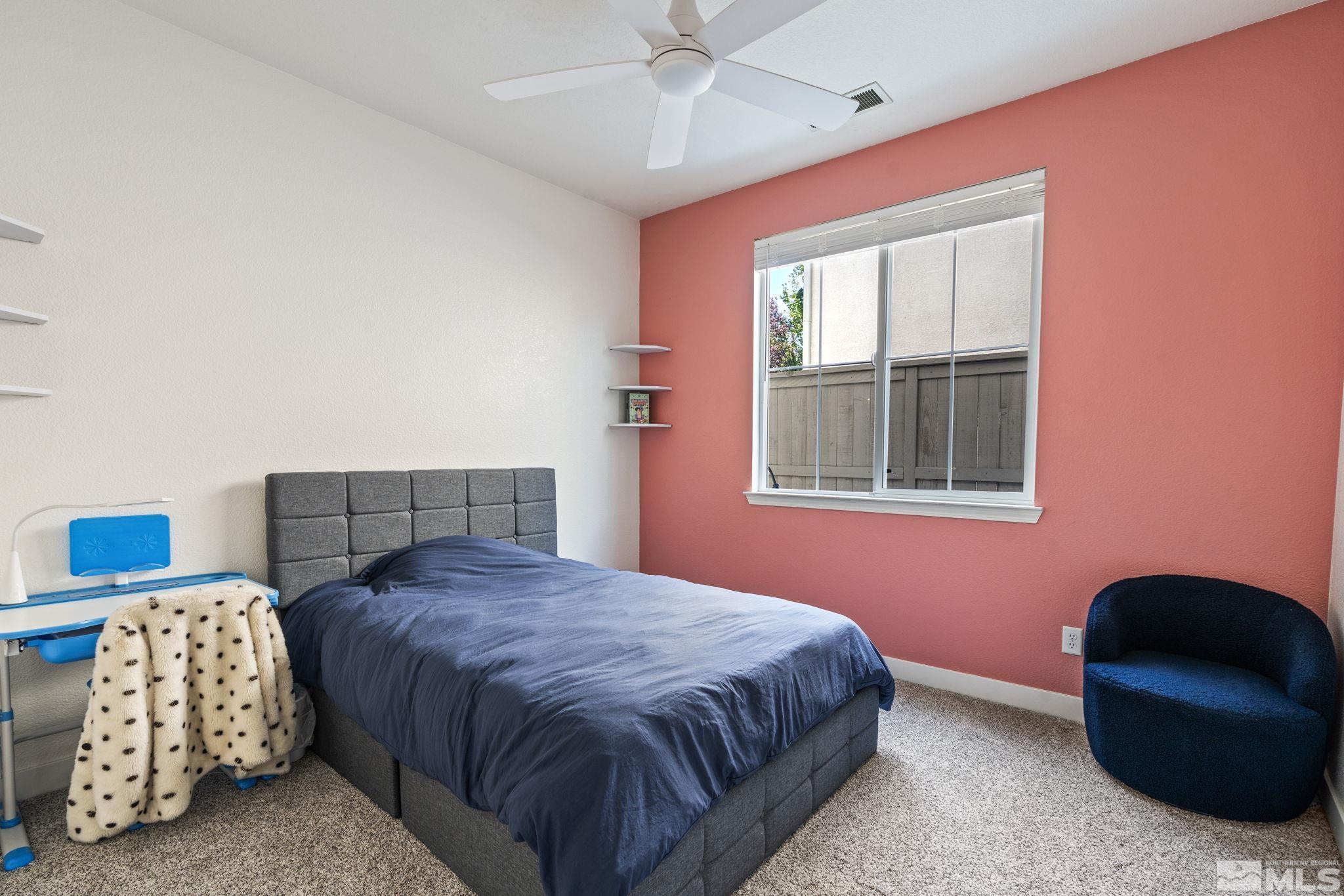 541 Needles Court Reno, NV 89521 - Photo 20 of 35 a bedroom with a bed and a chair