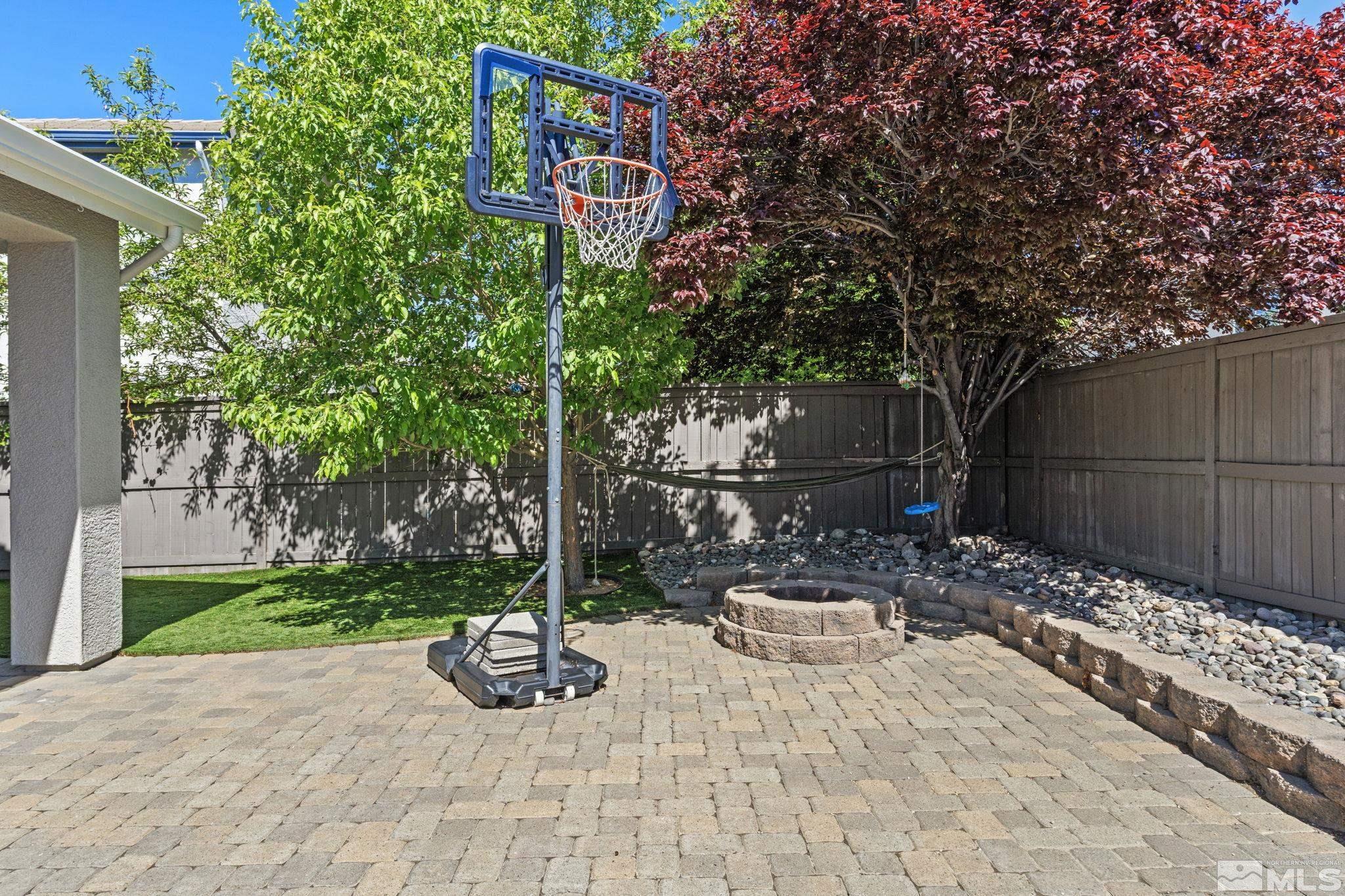 541 Needles Court Reno, NV 89521 - Photo 26 of 35 a white bench sitting in a backyard with wooden fence