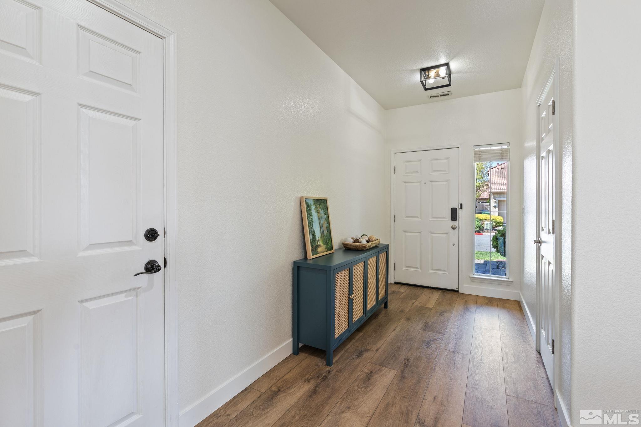 541 Needles Court Reno, NV 89521 - Photo 6 of 35 a view of a hallway view with wooden floor and staircase