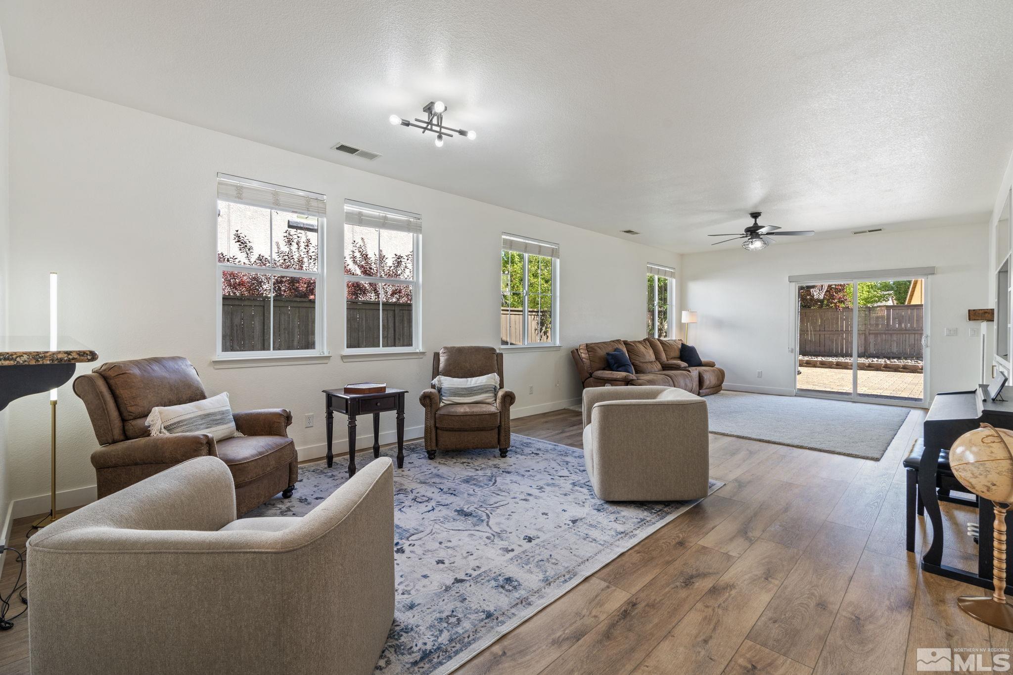 541 Needles Court Reno, NV 89521 - Photo 8 of 35 a living room with furniture and a wooden floor
