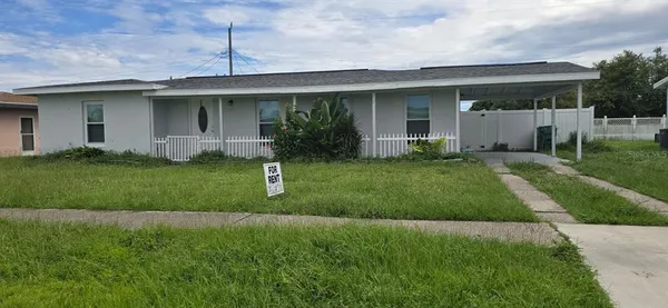 a front view of a house with a garden and yard