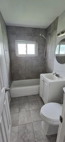 a bathroom with a toilet a sink and bathtub