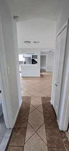 a view of a refrigerator in kitchen and a window