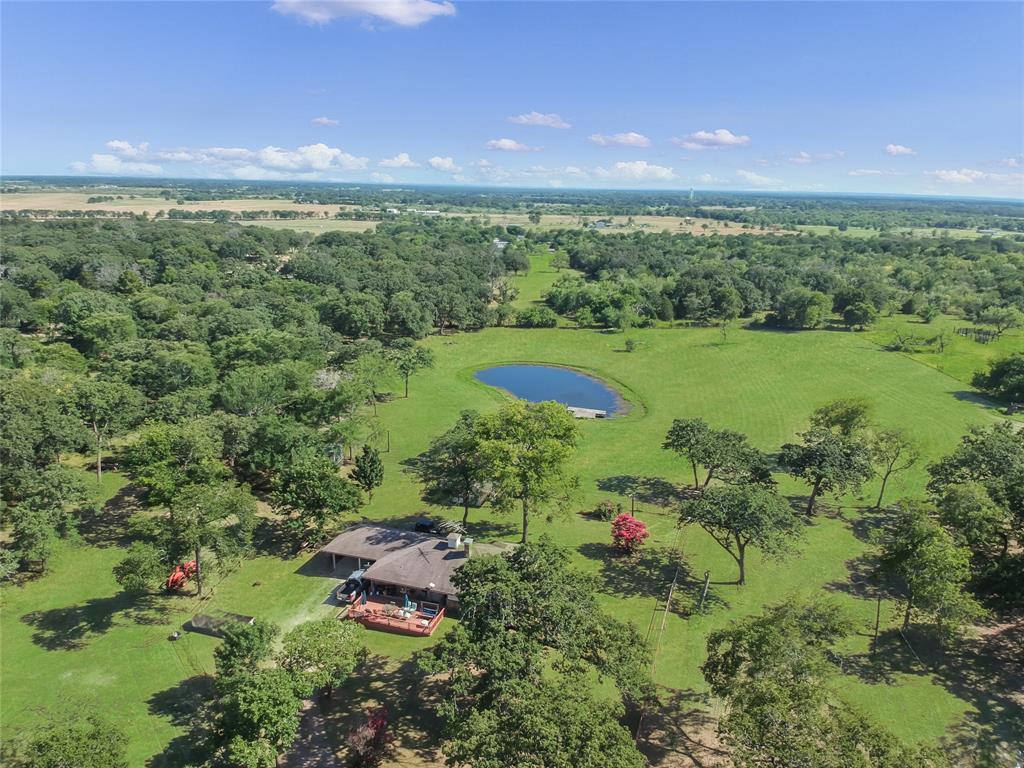 1001 Sandy Ridge Road Scurry, TX 75158 - Photo 1 of 35 Expansive property featuring a tranquil pond, generous green spaces, mature trees, and a residential structure with an extended deck