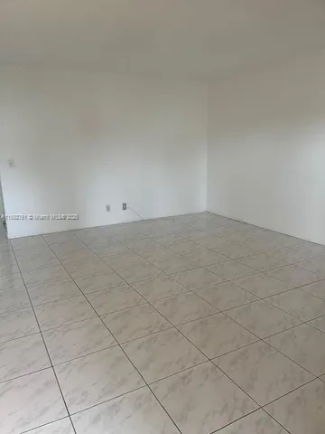 a view of a field of grass and trees