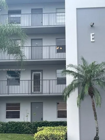a view of a chair and table in backyard