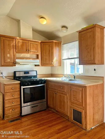 a kitchen with granite countertop wooden cabinets stainless steel appliances and a window