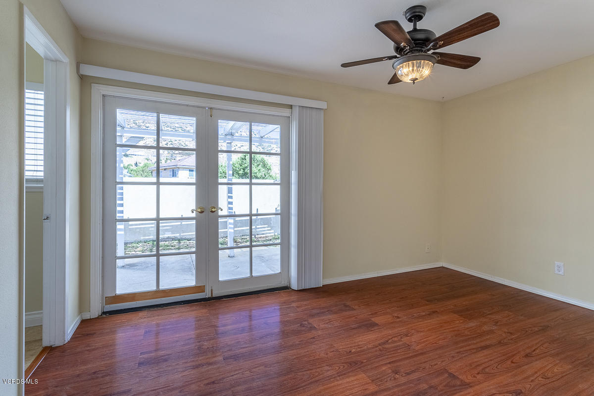 2276 Rohner Court Simi Valley, CA 93063 - Photo 14 of 20 an empty room with wooden floor fan and windows