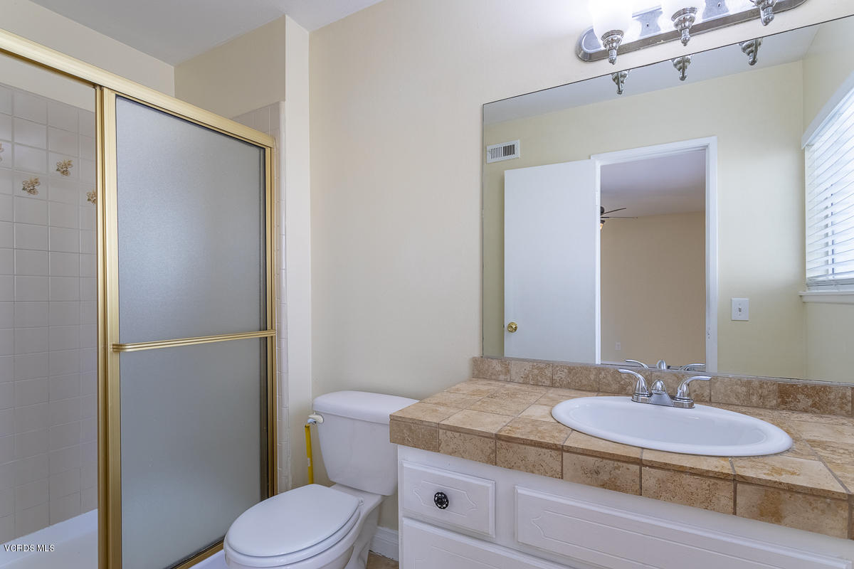 2276 Rohner Court Simi Valley, CA 93063 - Photo 16 of 20 a bathroom with a granite countertop sink toilet and mirror