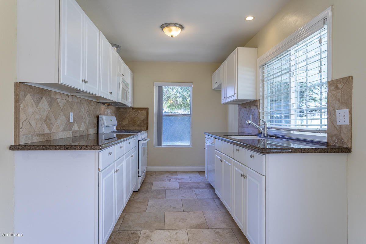 2276 Rohner Court Simi Valley, CA 93063 - Photo 8 of 20 a kitchen with granite countertop a sink and dishwasher a stove top oven with wooden floor