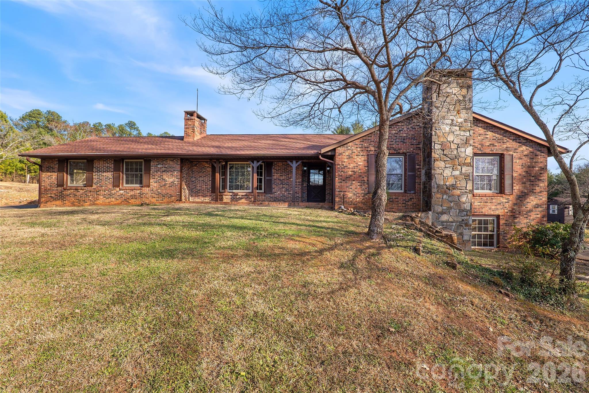 591 Landrum Road Tryon, NC 28782 - Photo 2 of 48 a front view of a house with garden