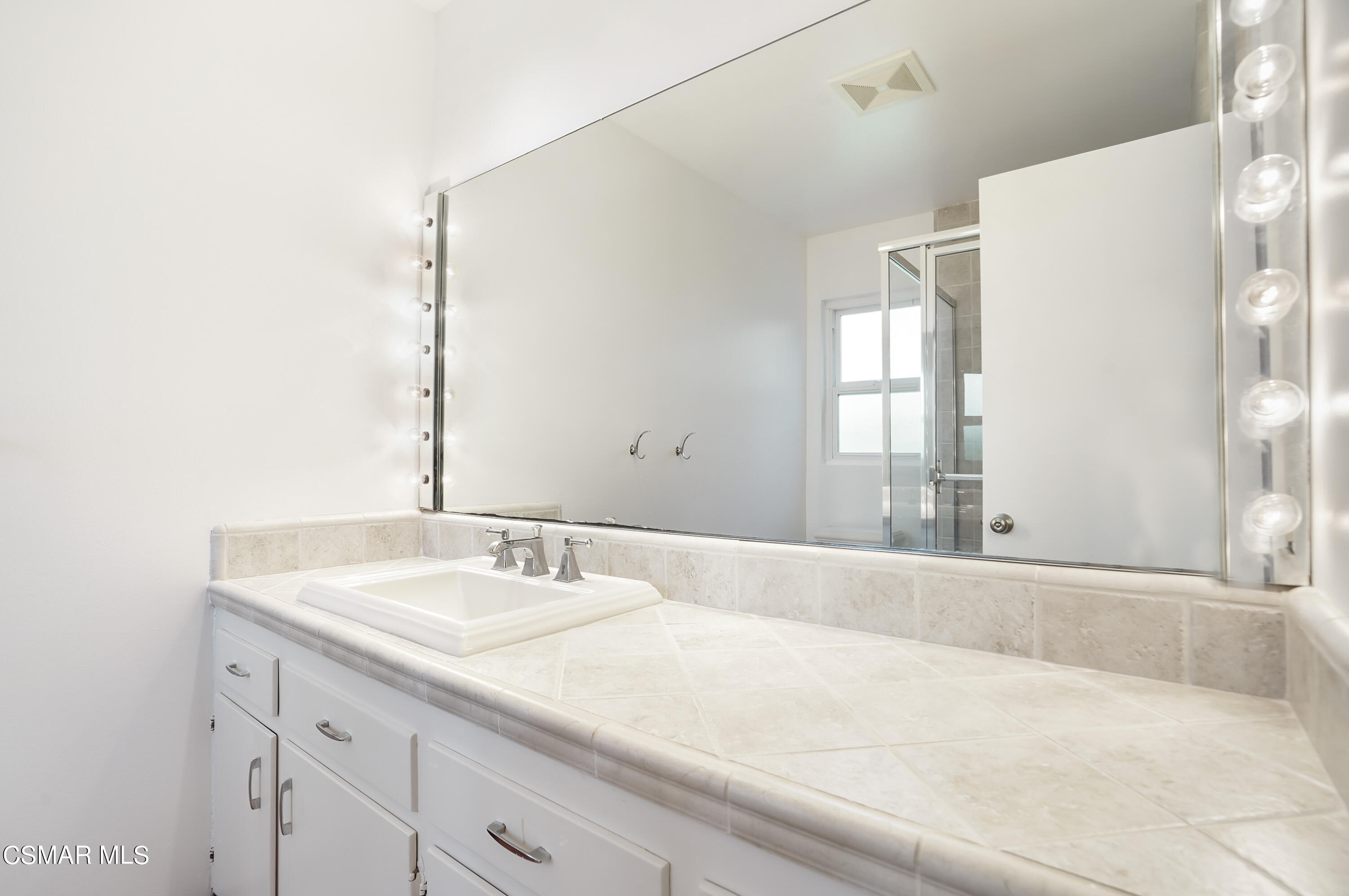 16 Mansfield Lane Camarillo, CA 93010 - Photo 11 of 22 a bathroom with a sink and a mirror