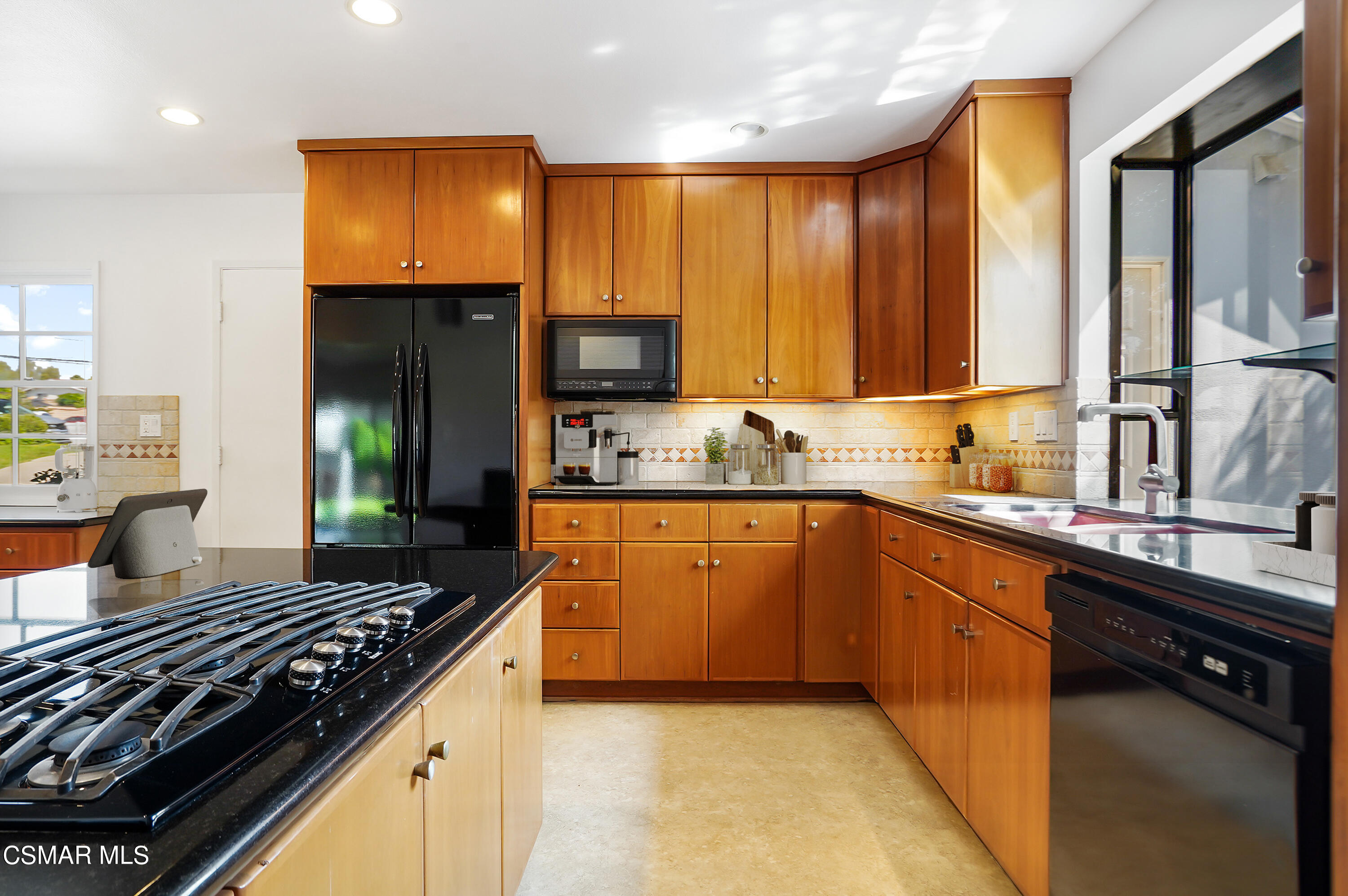 16 Mansfield Lane Camarillo, CA 93010 - Photo 5 of 22 a kitchen with stainless steel appliances granite countertop a stove a sink and a microwave