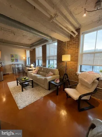 a bedroom with furniture and a large window