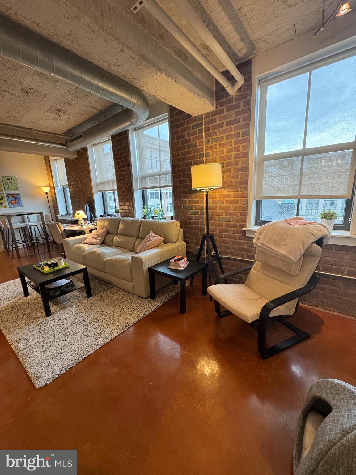 916 G St. Northwest, Unit 805 Washington, DC 20001 - Photo 15 of 19 a living room with furniture a window and a table
