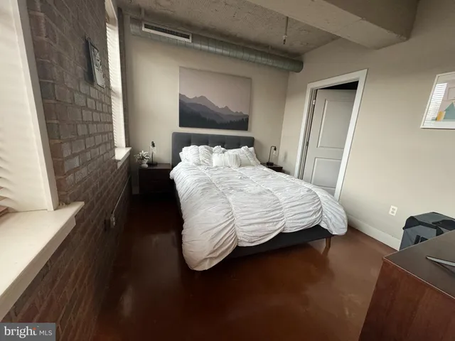 a bedroom with a bed and a window