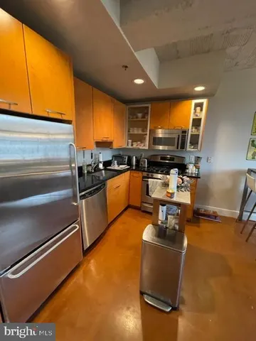 a kitchen with a sink appliances and cabinets