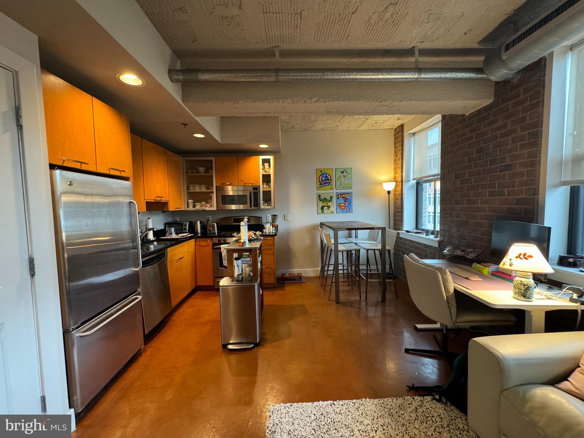 916 G St. Northwest, Unit 805 Washington, DC 20001 - Photo 10 of 19 a living room with stainless steel appliances kitchen island granite countertop furniture and a fireplace